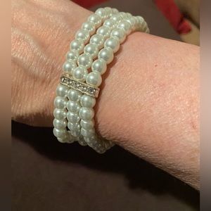 Triple Strand Faux Pearl Bracelet w/ gold & rhinestone accents. Elasticized.